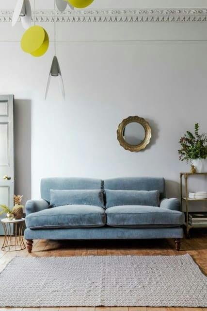 Salón blanco y sofá azul